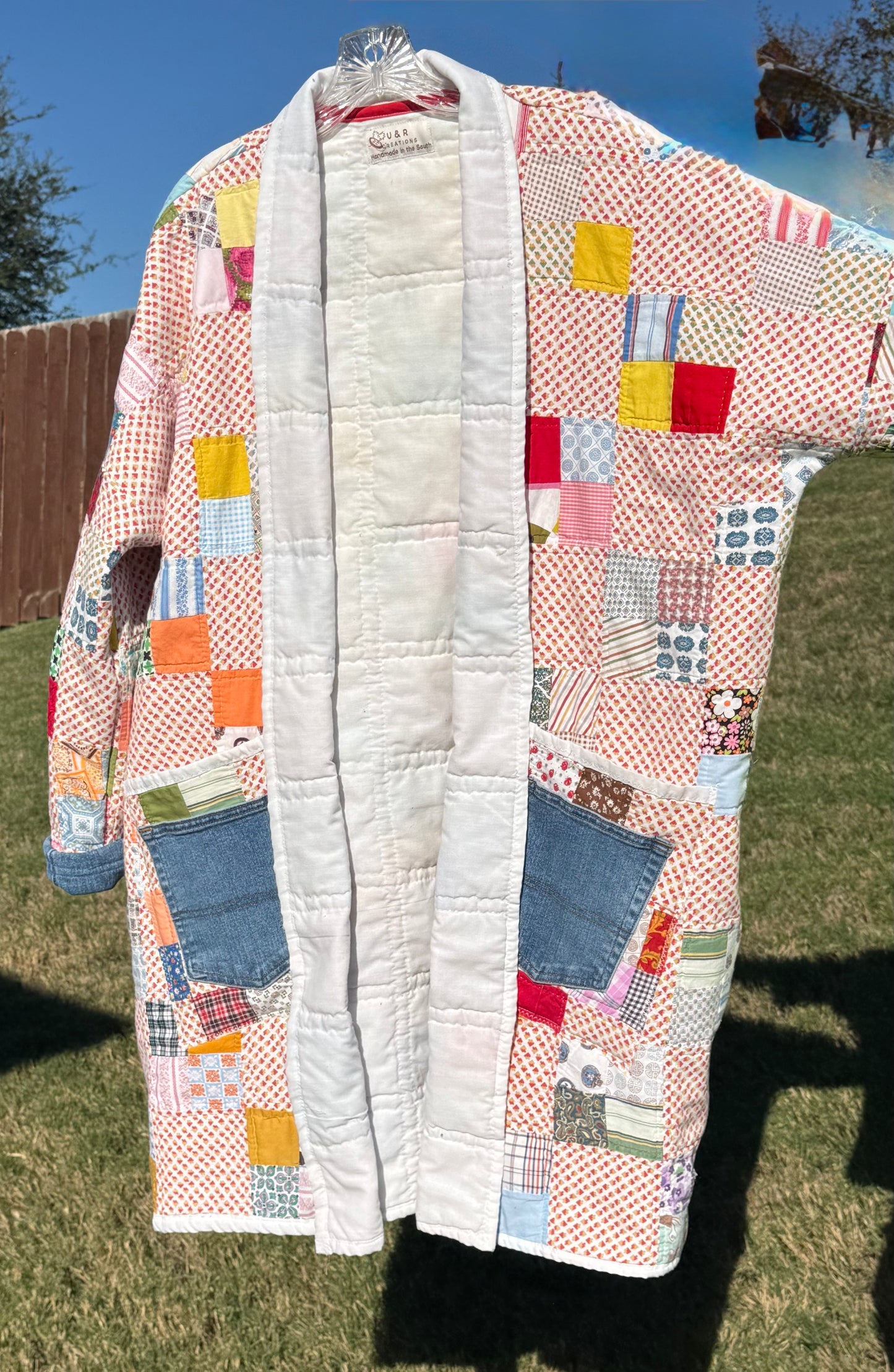 Hand quilted patchwork jacket with denim accents.  3/4 length & double pockets.  Size L (Fits S-XL)