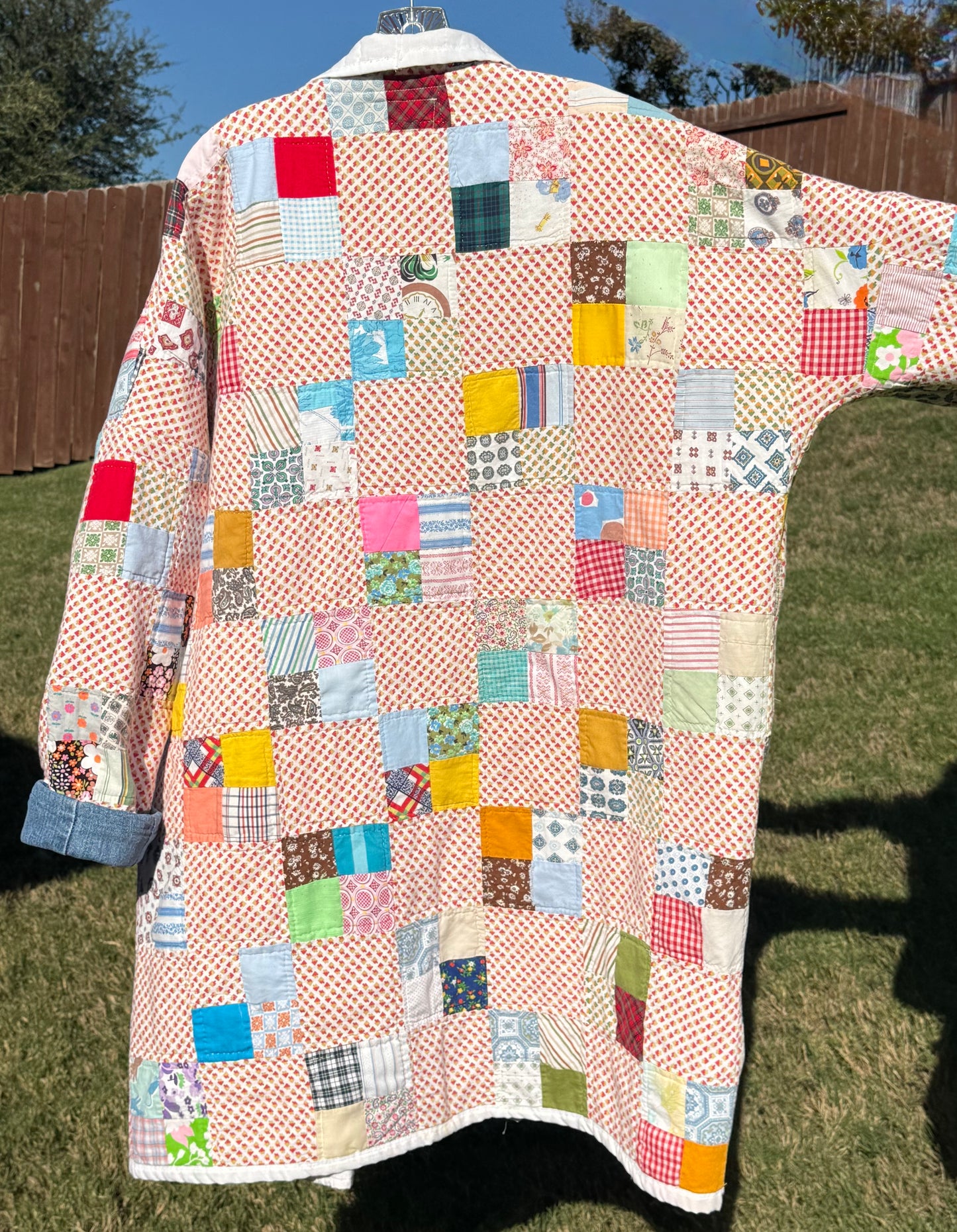 Hand quilted patchwork jacket with denim accents.  3/4 length & double pockets.  Size L (Fits S-XL)