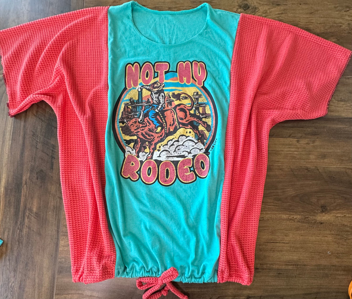 "Not my Rodeo" Teal T-Shirt with Coral accents.  One Size Fits Most.